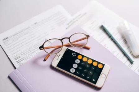 Calculator and financial documents representing will costs in Canada