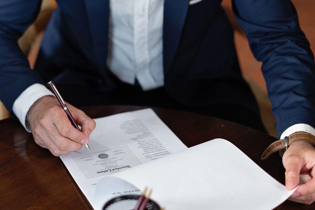 Person signing a will document in Canada at a desk without notarization