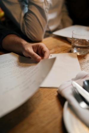 Two witnesses watching someone sign a will document in Canada