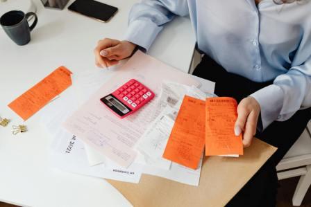 Alberta resident calculating probate fees on estate documents at home