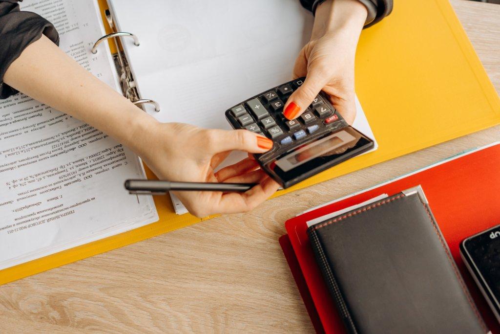 Ontario resident calculating probate fees on estate documents at home