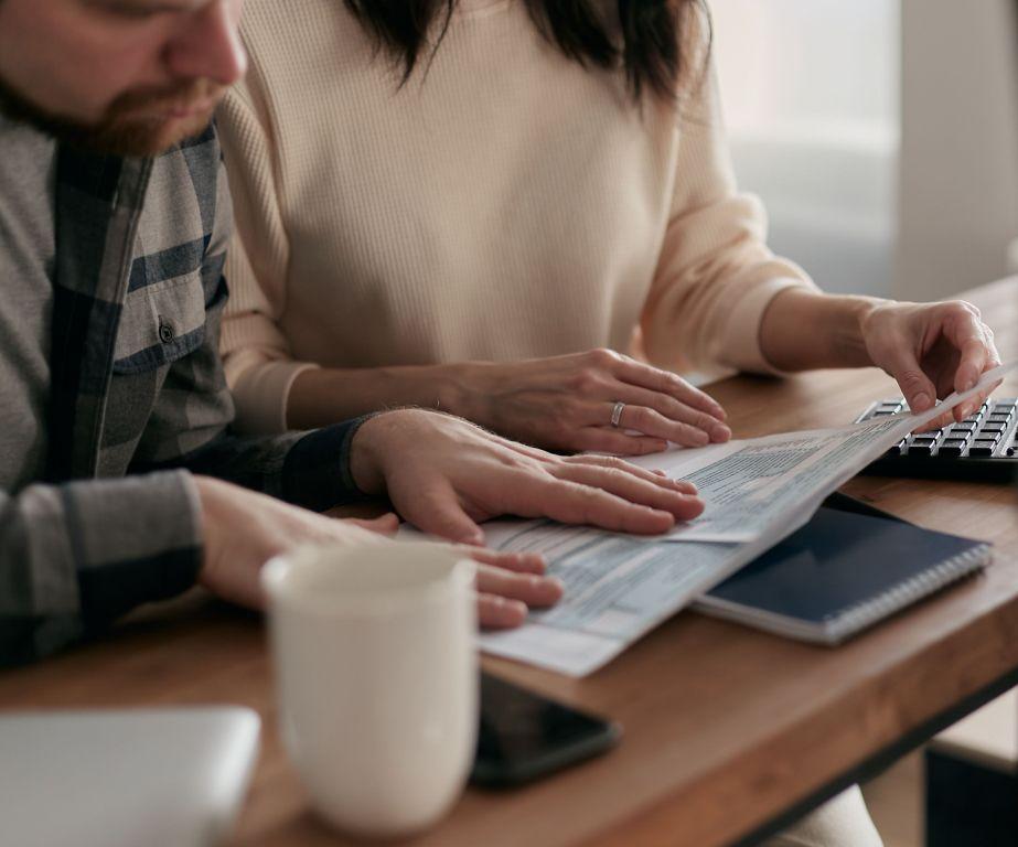 Canadian adult reviewing executor and beneficiary roles for their will at a home office desk